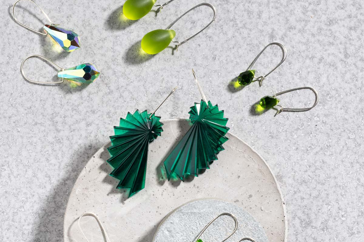 Flat lay of earrings from Betsy Blonde featuring green colours