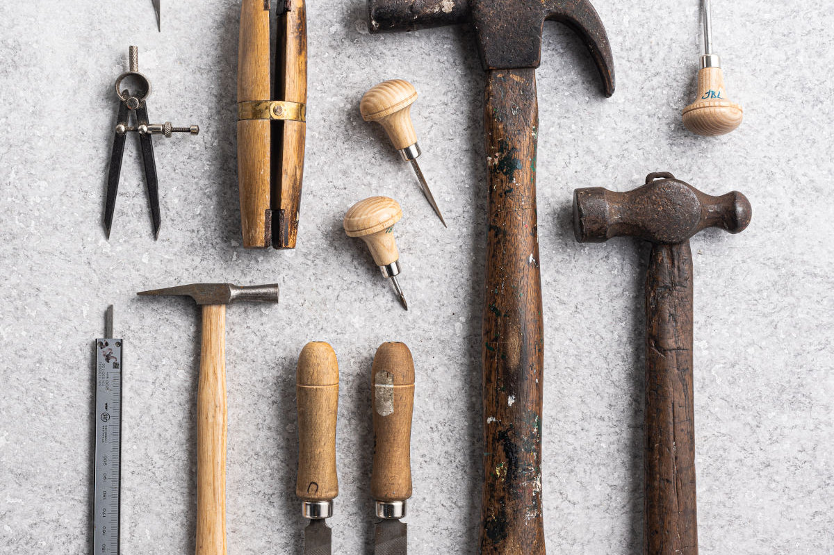 Flat lay of jewellery making tools from Betsy Blonde studio including hammers and files and pliers 